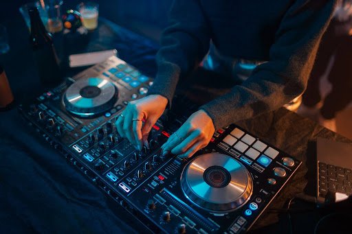 Professional DJ services in Darien, CT with a DJ mixing music on a controller at a live event.